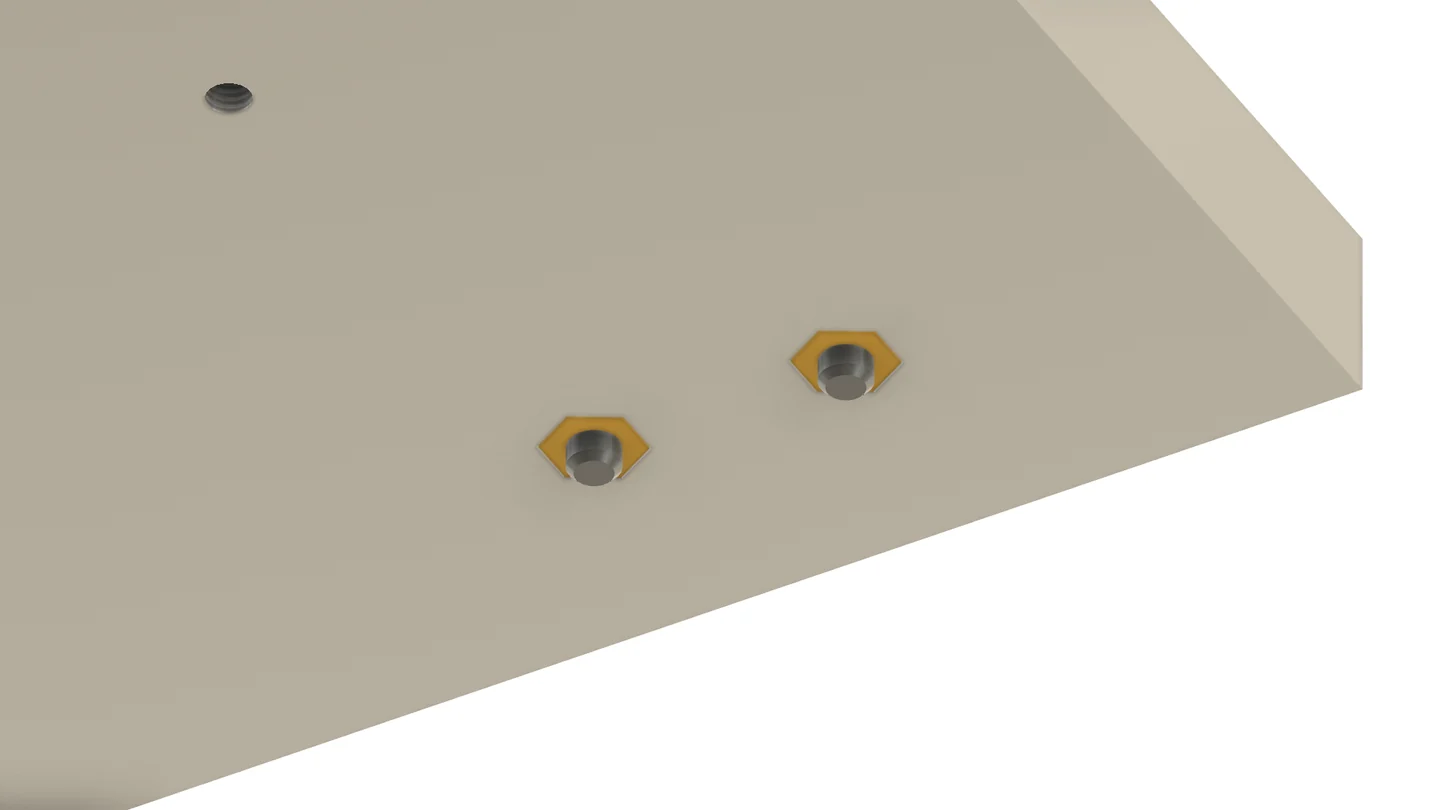 Underside of the fixture plate with two yellow captive nuts in hexagon pockets