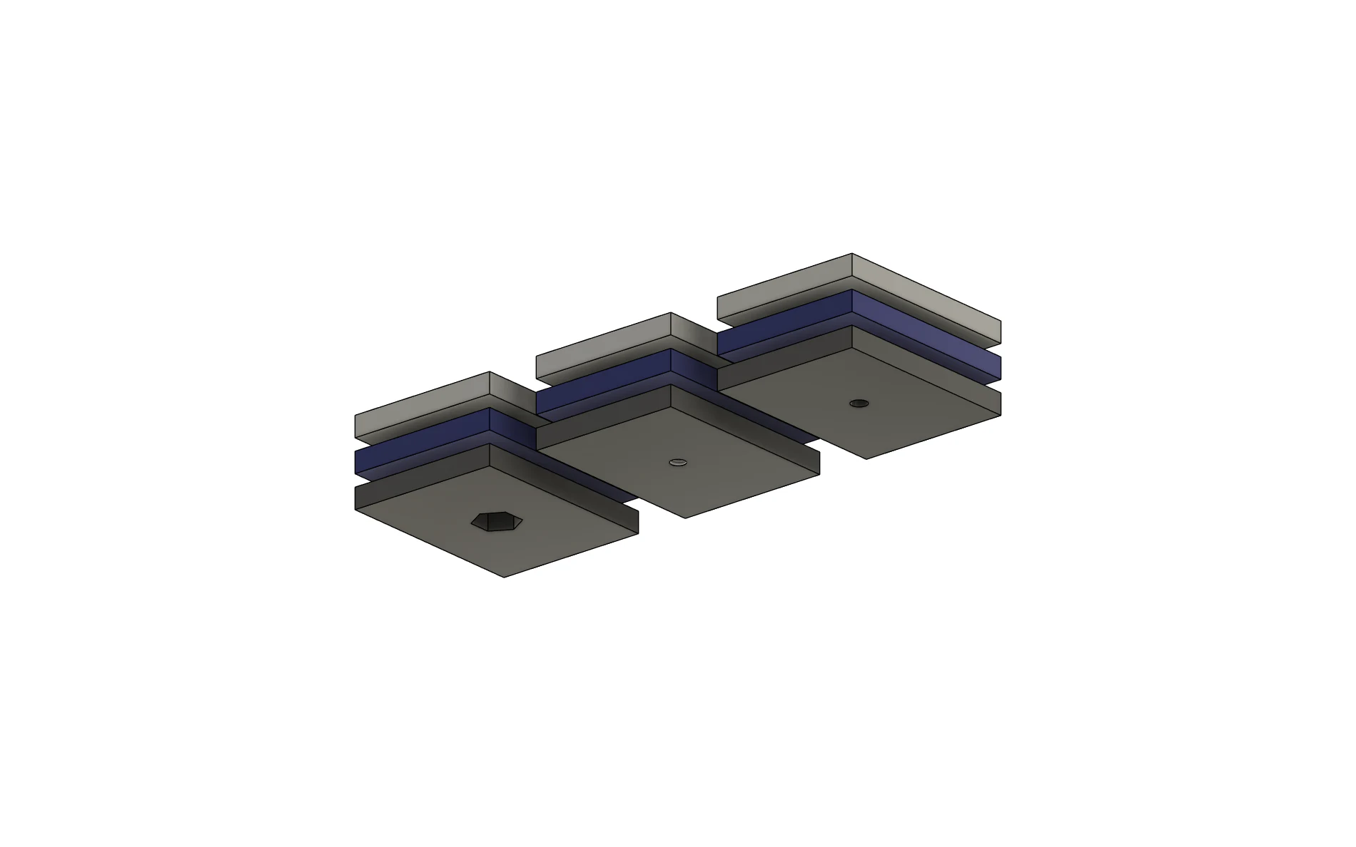 Underside of the dedicated three-layer hole test piece showing tapped exits and hexagonal nut pockets